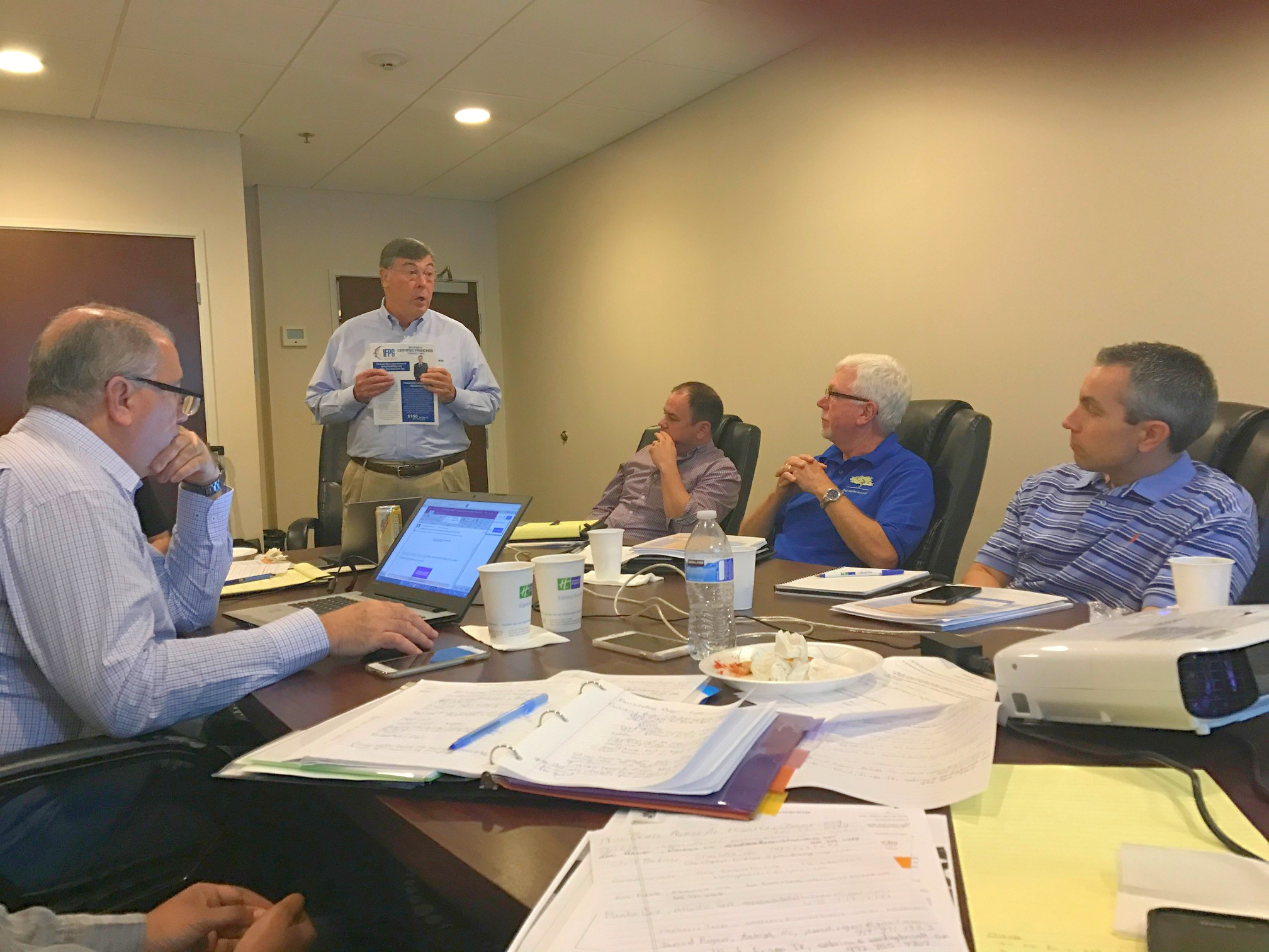 Tom Arndt at a table closing a sale for an auto repair company